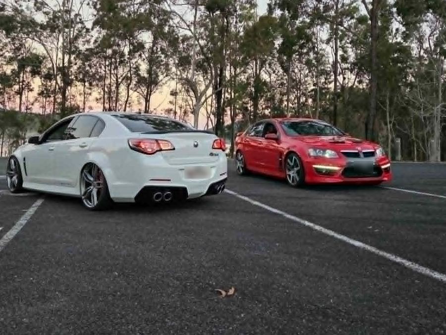 White HSV Gen-F and red HSV E-Series GTS at dusk